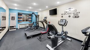 A gym with treadmills, a stationary bike, and a wall with motivational text. - Microtel Inn & Suites by Wyndham Greenville / Woodruff Rd (Greenville)