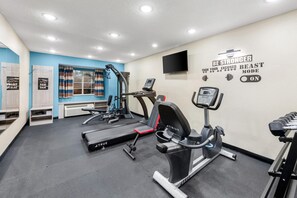 A gym with treadmills, a stationary bike, and a wall with motivational text. - Microtel Inn & Suites by Wyndham Greenville / Woodruff Rd (Greenville)