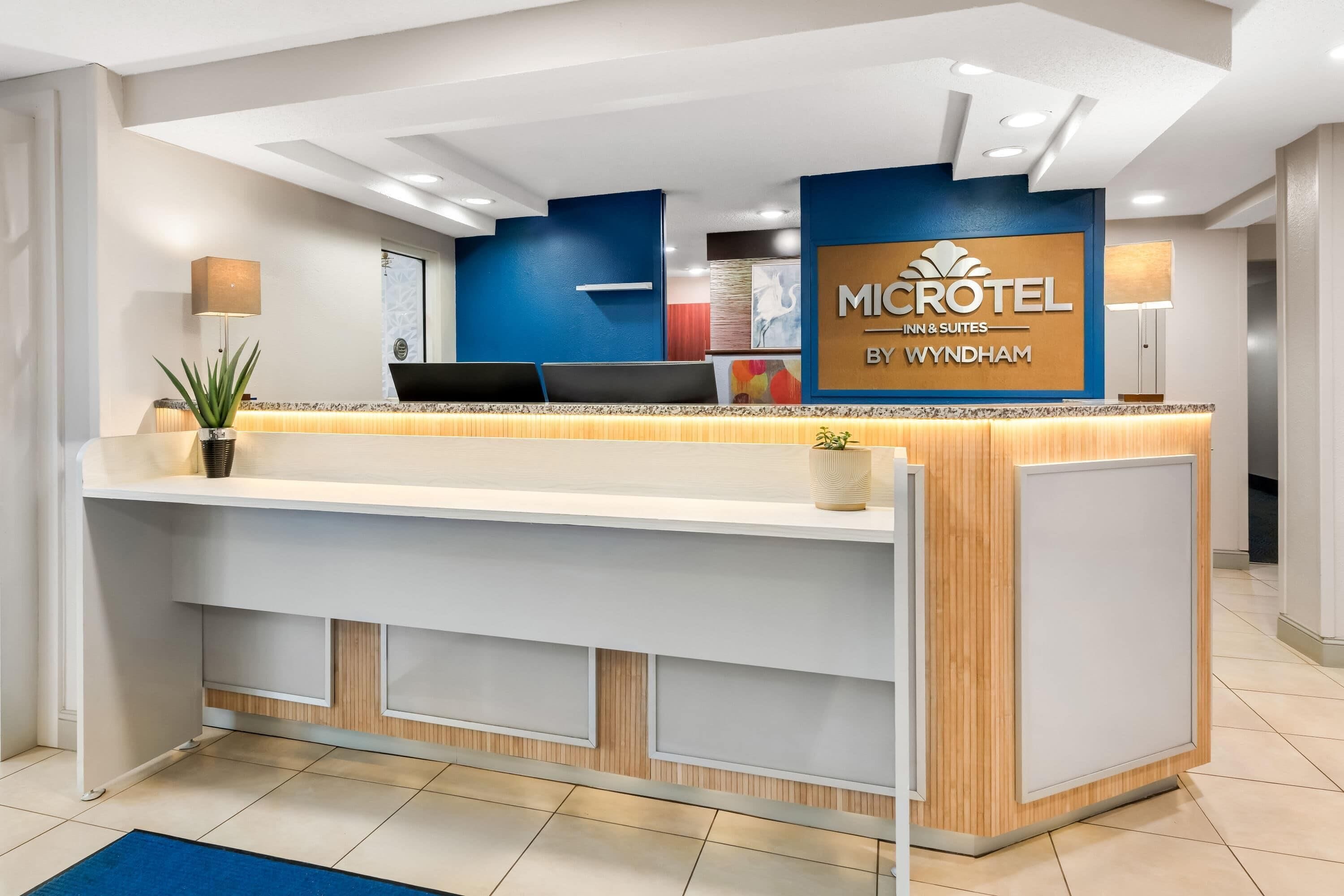 A reception desk with a sign for Microtel Inn & Suites by Wyndham.
