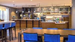 A modern bistro with a bar area, seating, and a menu display. - Courtyard by Marriott Hartford Manchester (Manchester)