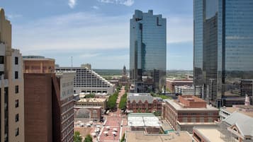 A cityscape with modern and historic buildings, a clear sky, and a view of the downtown area.