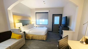 A hotel room with a bed, a sofa, a desk, a television, and a window. - Country Inn & Suites by Radisson, Fort Worth West l-30 NAS JRB (Fort Worth)