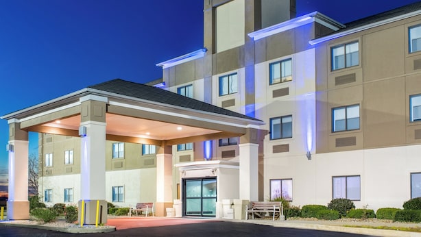 A multi-story hotel with a covered entrance and a flat roof.