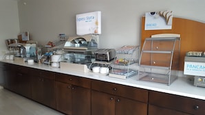 A breakfast buffet with various food items, a toaster, and a sign for 'Express Start'.