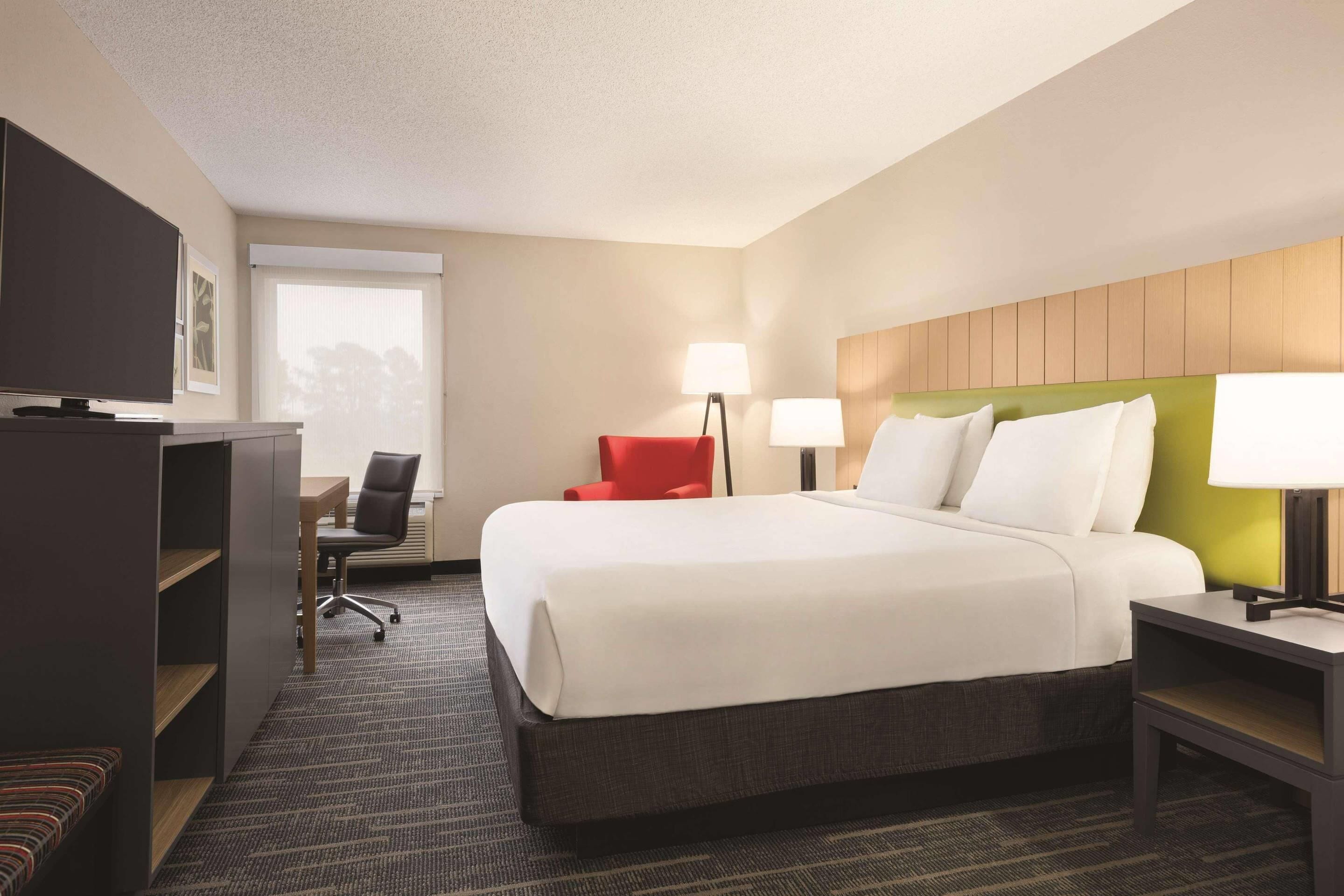 Premium bedding, desk, laptop workspace, blackout drapes
