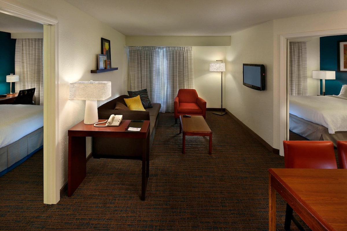 Premium bedding, desk, laptop workspace, blackout drapes