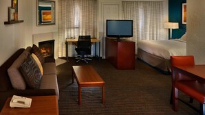A hotel room with a sofa, a desk with a computer, a television, a bed, and a small table. - Residence Inn Marriott Danbury (Danbury)