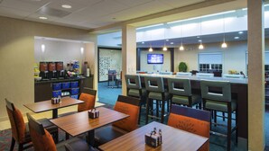 A hotel lobby with a coffee station, seating area, and a TV screen. - Residence Inn Marriott Danbury (Danbury)
