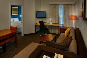 Premium bedding, desk, laptop workspace, blackout drapes