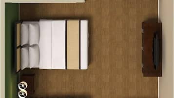 Habitación de hotel pequeña con cama, un escritorio, una silla, un inodoro y un lavamanos.