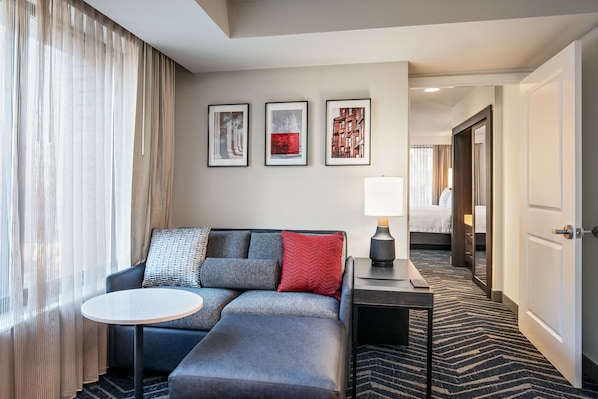 Premium bedding, desk, laptop workspace, blackout drapes