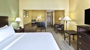 A hotel room with a large bed, a desk with a chair, a small kitchenette, and a TV. - Country Inn & Suites by Radisson, Benton Harbor-St. Joseph, MI (Benton Harbor)