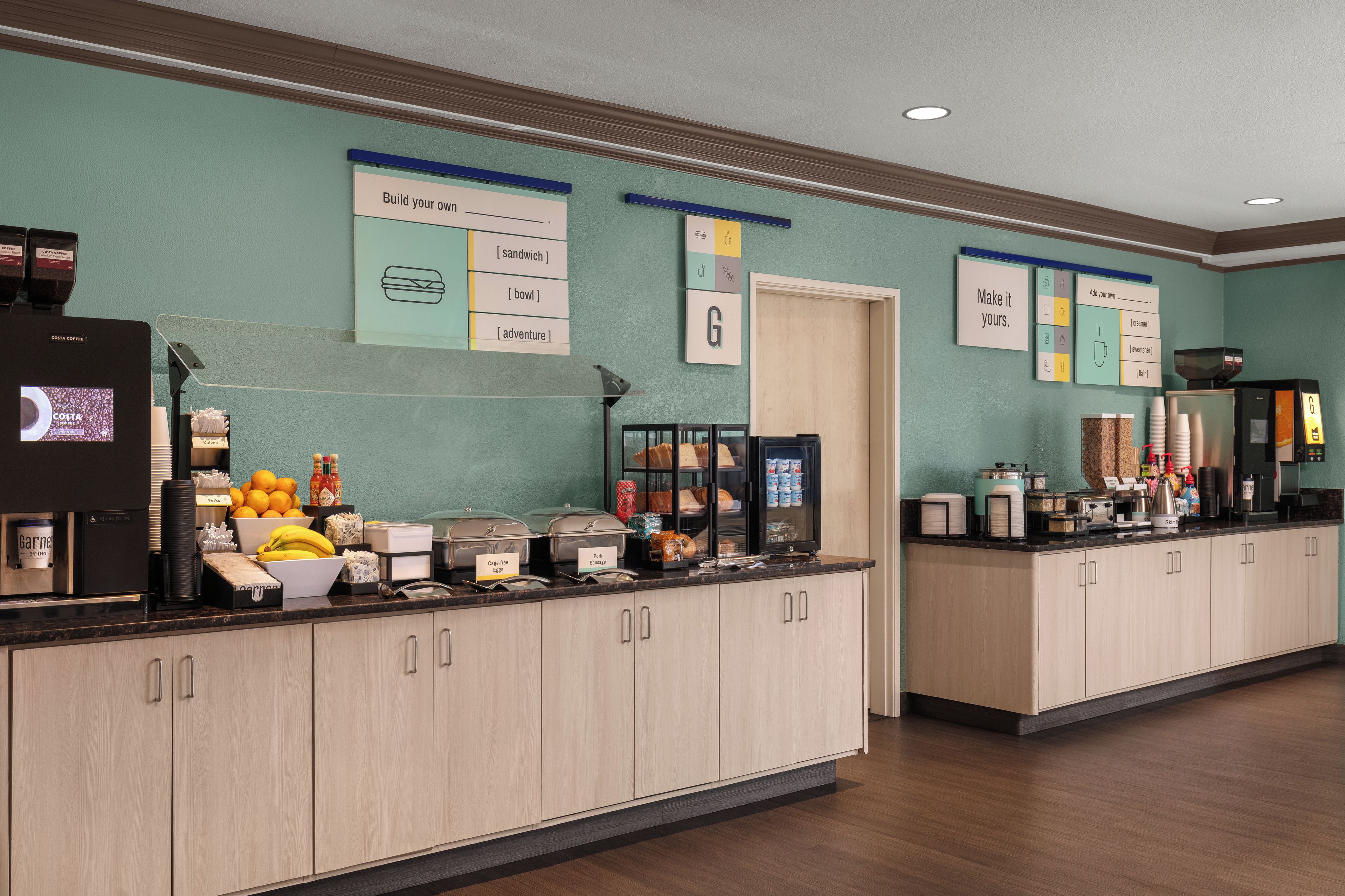 A self-serve breakfast station with labeled food options and a coffee machine.