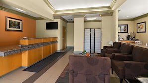 A reception area with a wooden counter, seating area with sofas, and a traditional Japanese room divider. - Best Western Willits Inn (Willits)