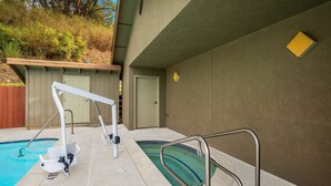 A pool area with a diving board, a small shed, and a door. - Best Western Willits Inn (Willits)