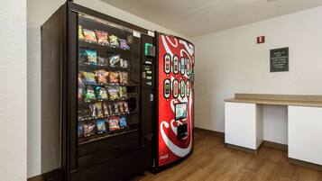A vending machine with snacks and a Coca-Cola branded machine.