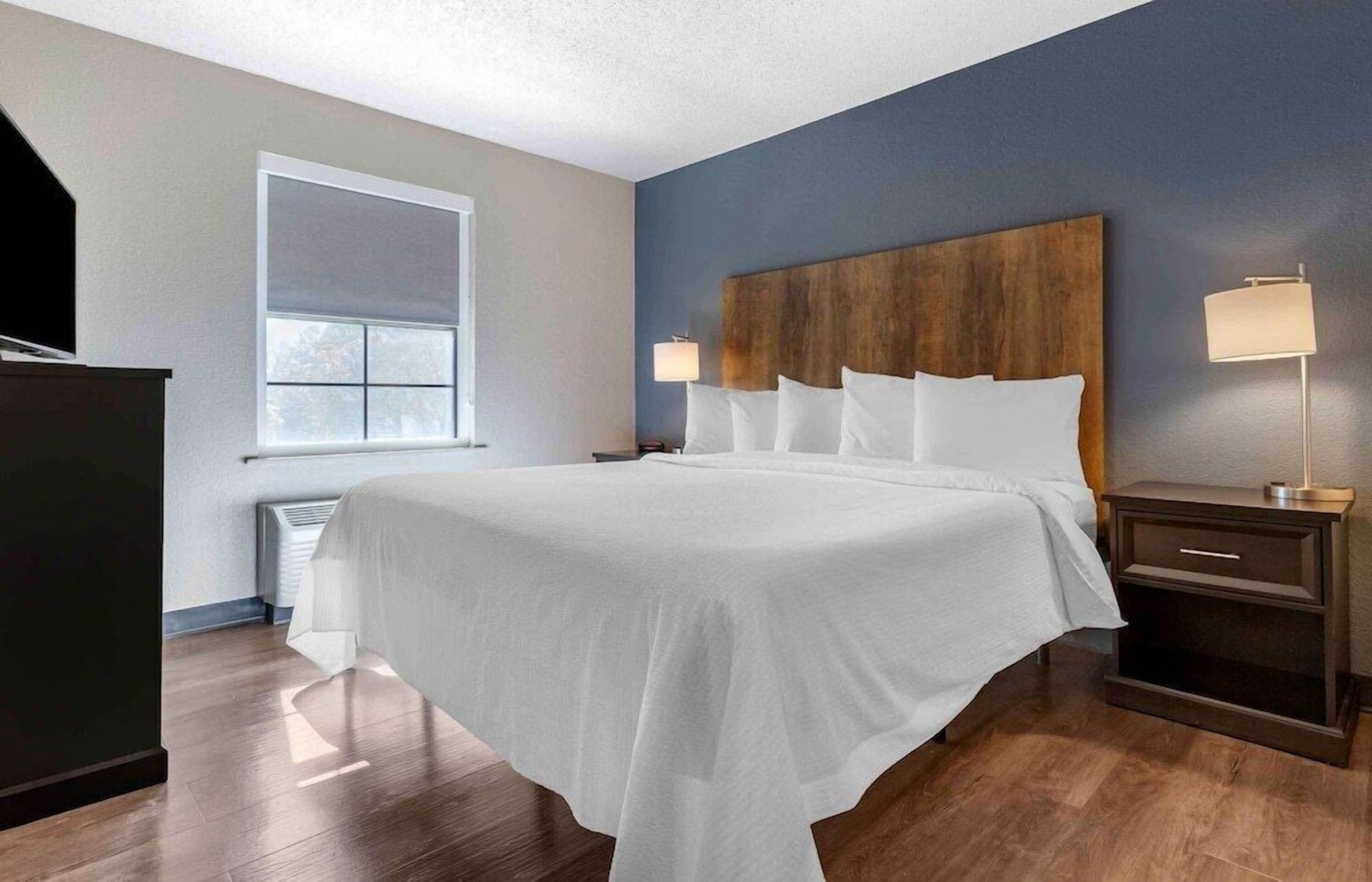 Premium bedding, desk, laptop workspace, blackout drapes