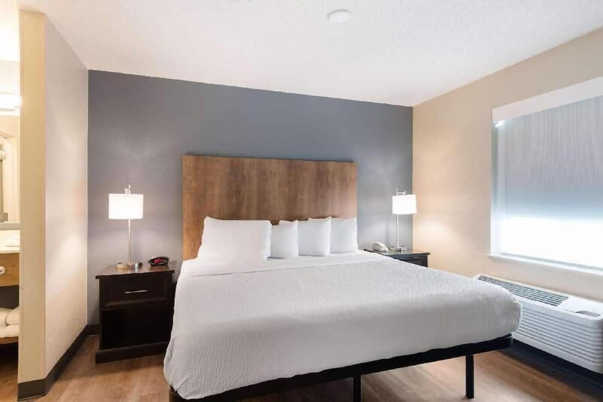 Premium bedding, desk, laptop workspace, blackout drapes