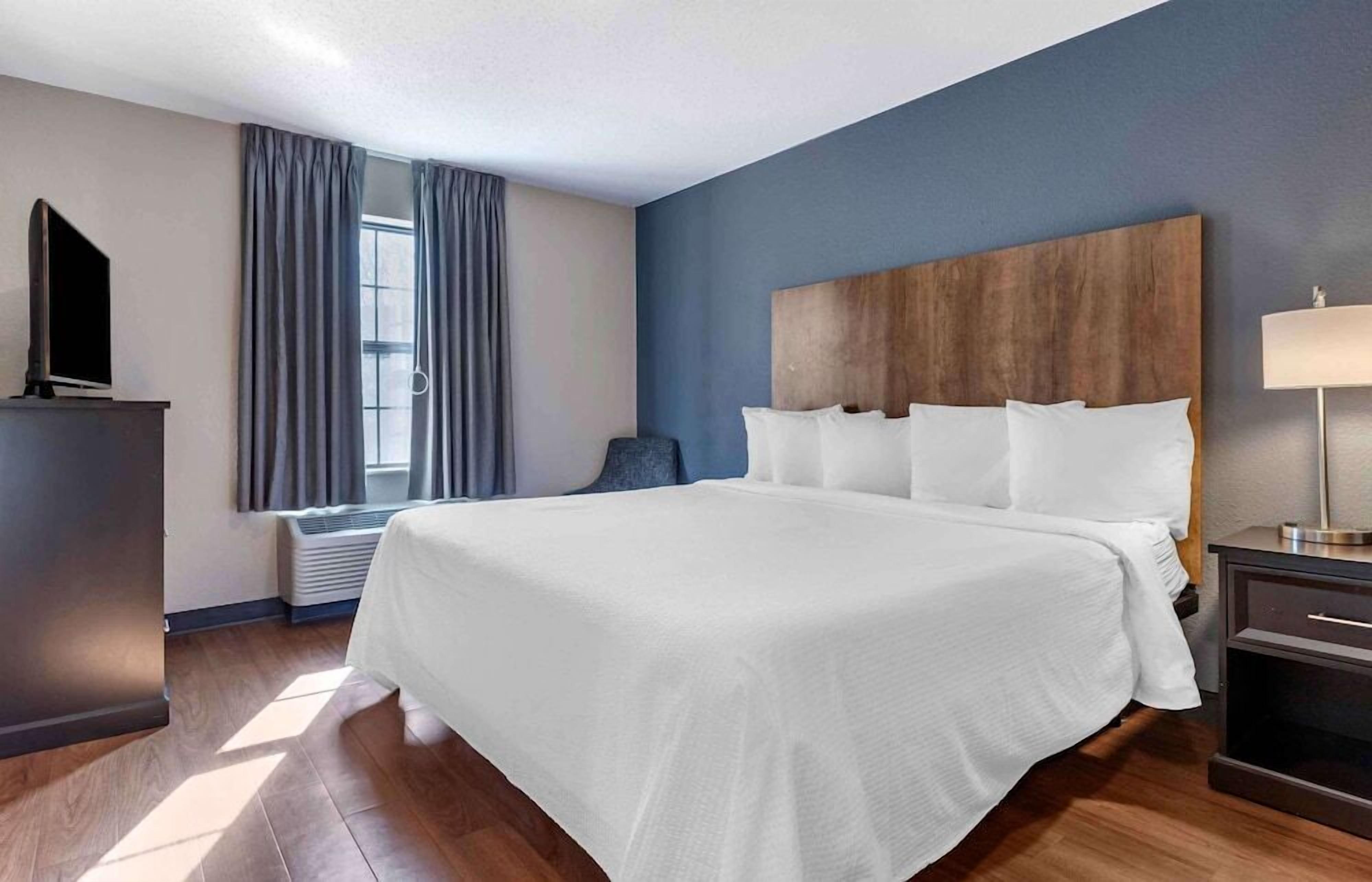 Premium bedding, desk, laptop workspace, blackout drapes