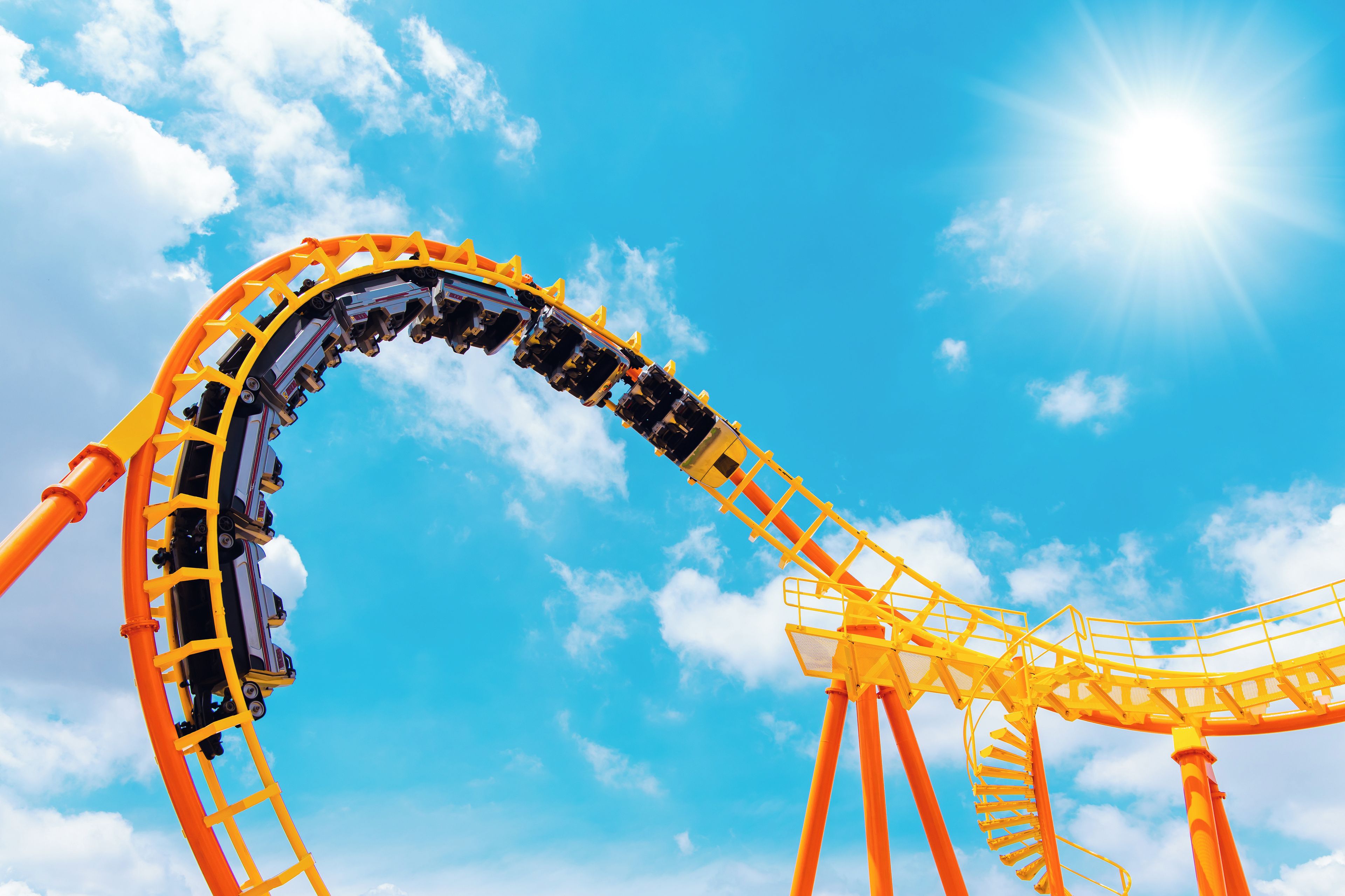 A roller coaster track against a clear blue sky.