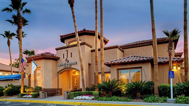 A resort building with a sign reading "Desert Paradise Resort".