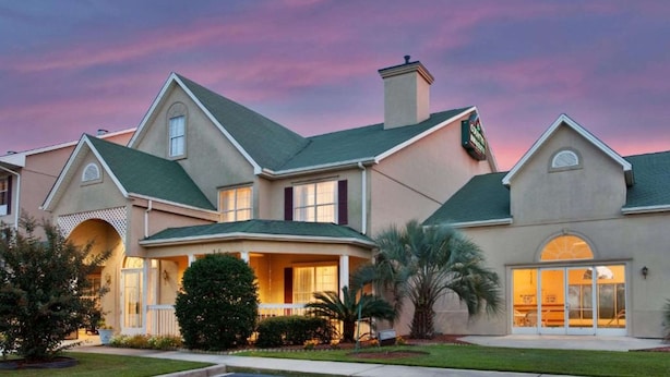 A large, two-story house with a wrap-around porch, a chimney, and a garage. - Country Inn & Suites by Radisson, Columbia, SC (Columbia)