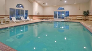 An indoor swimming pool with clear water, surrounded by lounge chairs and a tiled floor. - Country Inn & Suites by Radisson, Columbia, SC (Columbia)