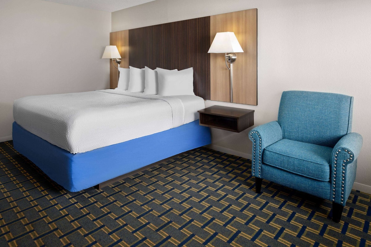 Premium bedding, desk, laptop workspace, blackout curtains