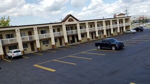 A motel with multiple floors, a parking lot with marked spaces, and a Burger King across the street. - Days Inn by Wyndham Tonawanda/Buffalo (Tonawanda)