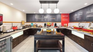 A modern kitchen with a central island, breakfast bar, and various appliances. - Hampton Inn Phoenix-Airport North (Phoenix)