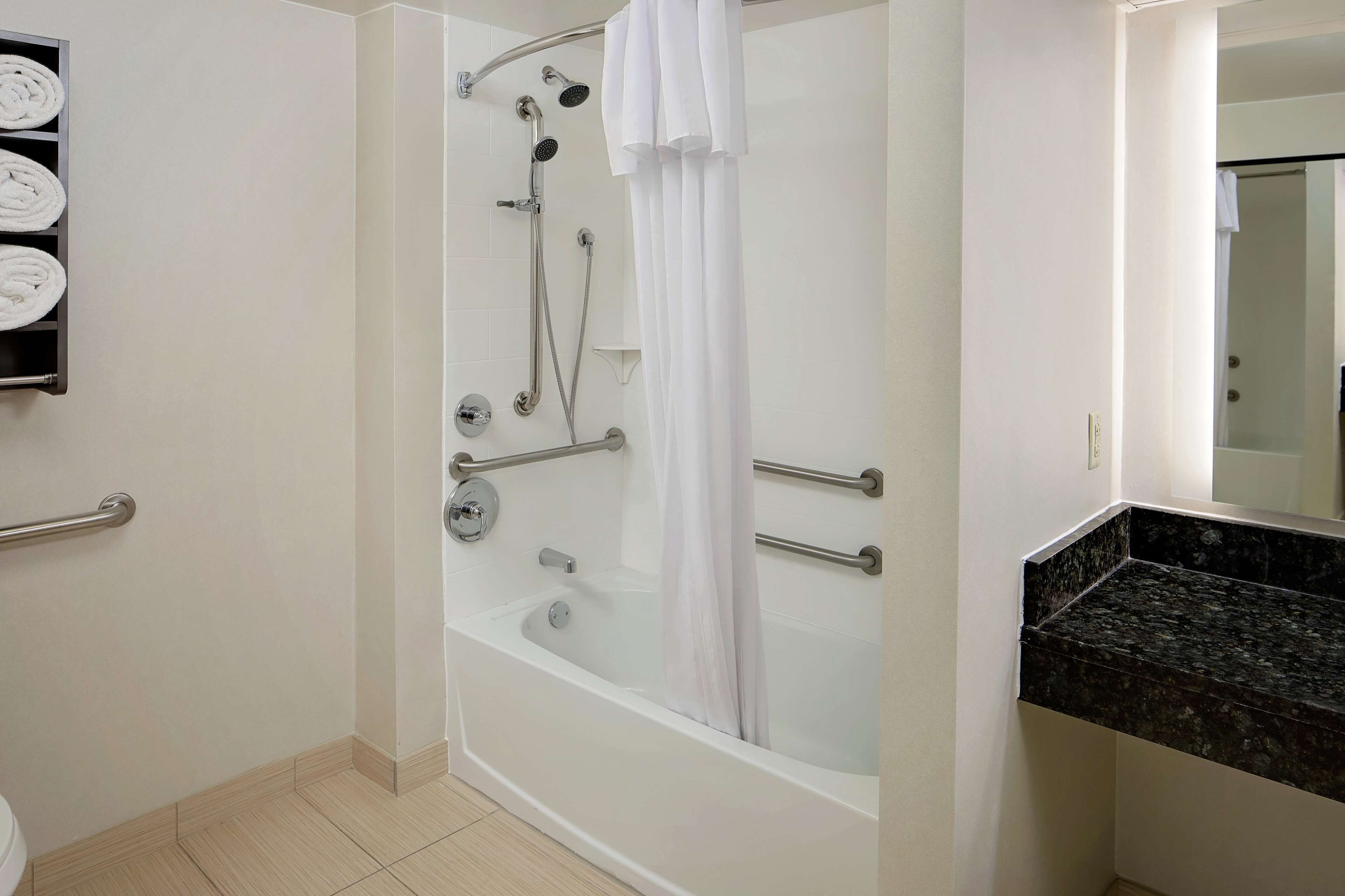 combined shower/bathtub, designer toiletries, hair dryer, towels