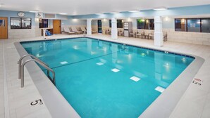 A swimming pool with lounge chairs and a pool lift.