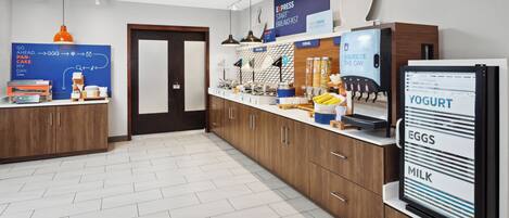 A modern kitchen with a breakfast bar, a refrigerator with yogurt, eggs, and milk, and a coffee machine.