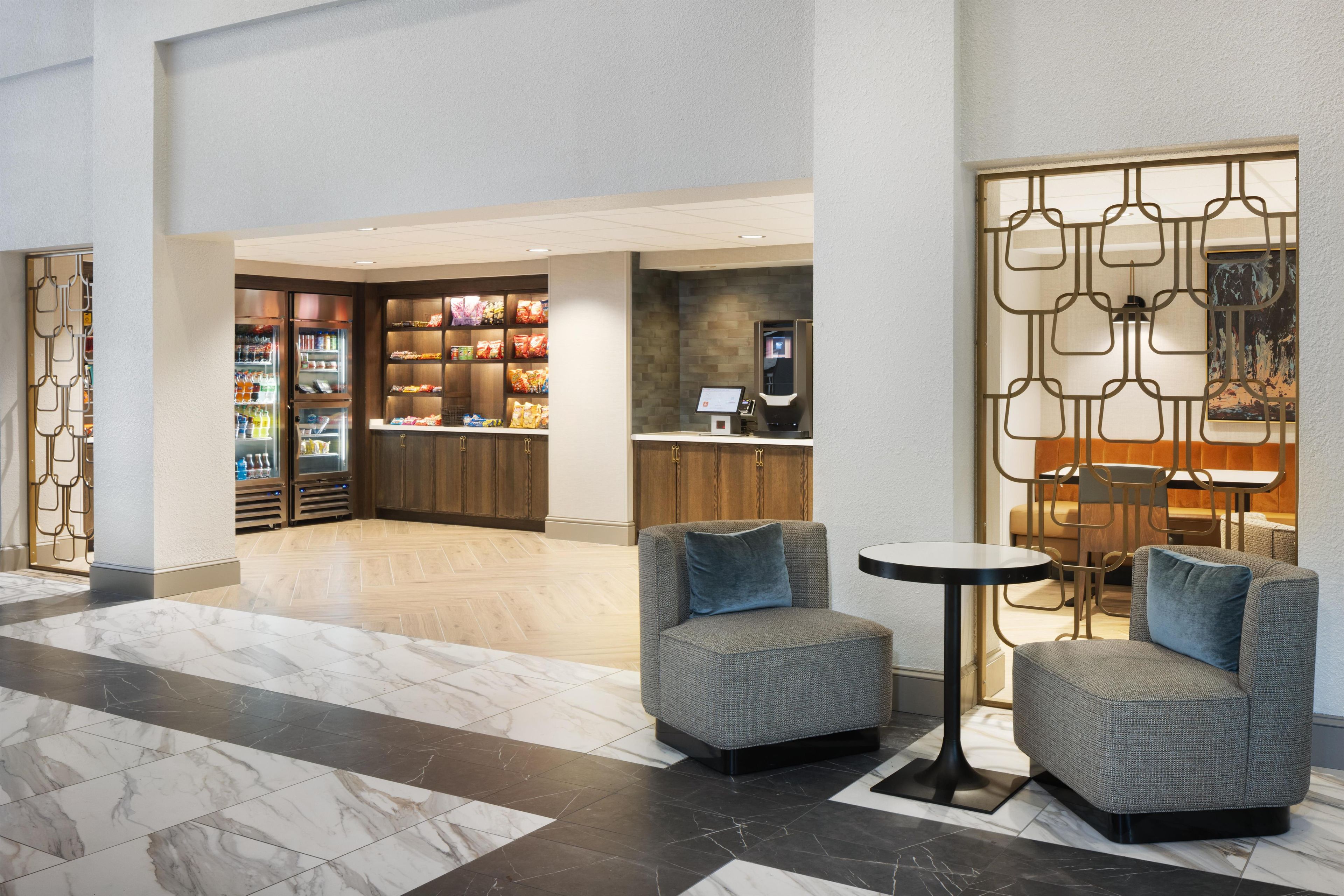 A lobby area with seating, a snack bar, and a reception desk.