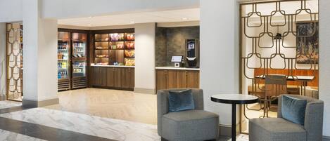 A lobby area with seating, a snack bar, and a reception desk.