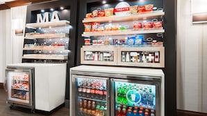 A vending area with snacks and drinks, including chips, sodas, and bottled water. - Hampton Inn Boston/Marlborough (Marlborough)