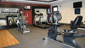 A gym with treadmills, elliptical machines, and a mirror. - Hampton Inn Olive Branch (Olive Branch)