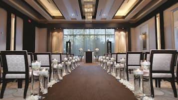 A conference room with a long table, chairs, and a podium at the front.