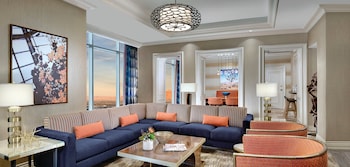 A hotel lobby with a reception desk, seating area, and a large decorative rug. at Mandalay Bay Resort And Casino