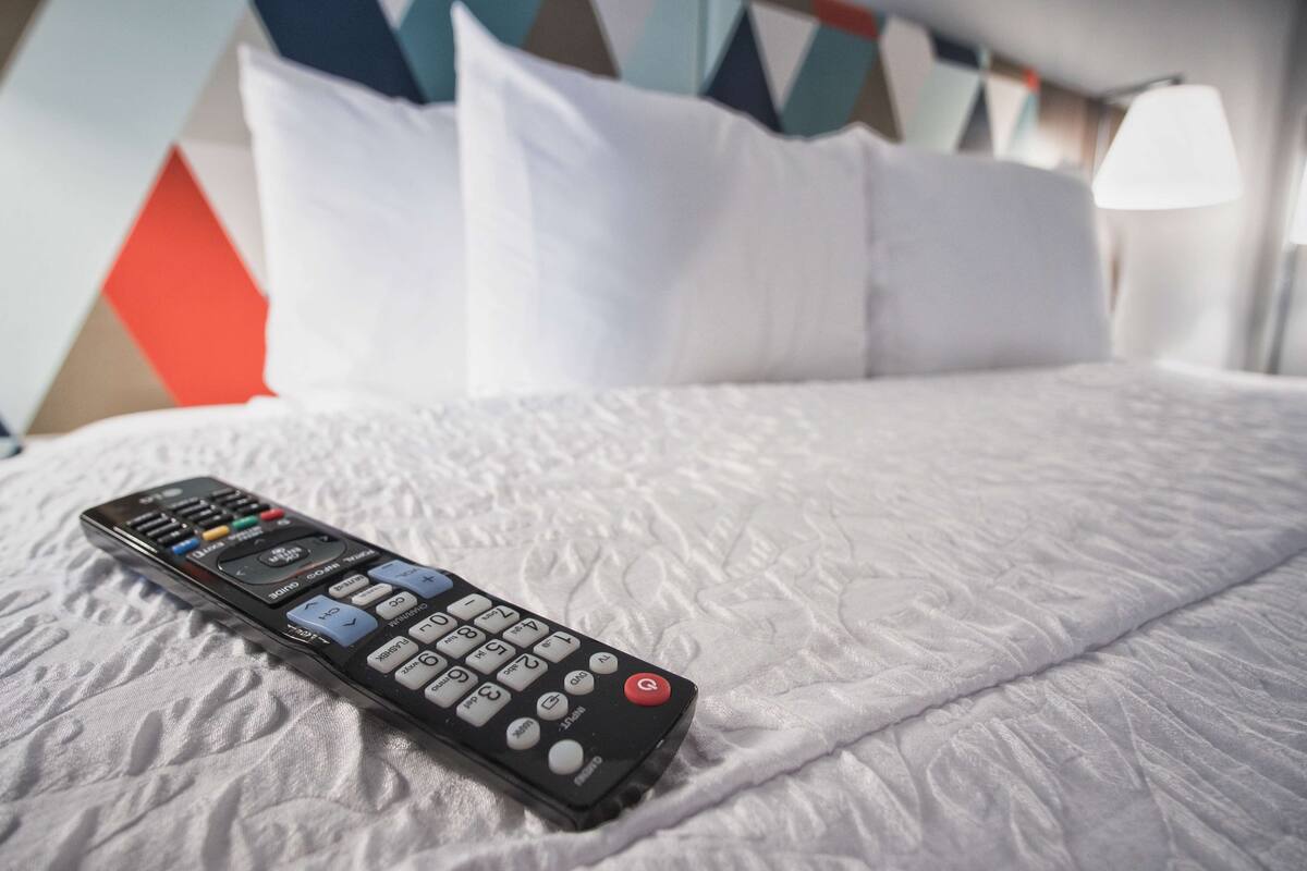 A bed with a remote control on it.