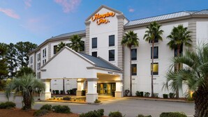 Ein Hampton Inn Hotel mit klassischer Architektur, das ein markantes Schild, einen einladenden Eingang und eine gepflegte Außenansicht zeigt.