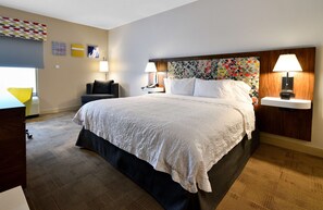 A hotel room with a large bed, two bedside tables with lamps, a chair, and a desk. - Hampton Inn Santee-I-95 (Santee)