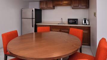 A compact kitchen with a refrigerator, microwave, and coffee maker.