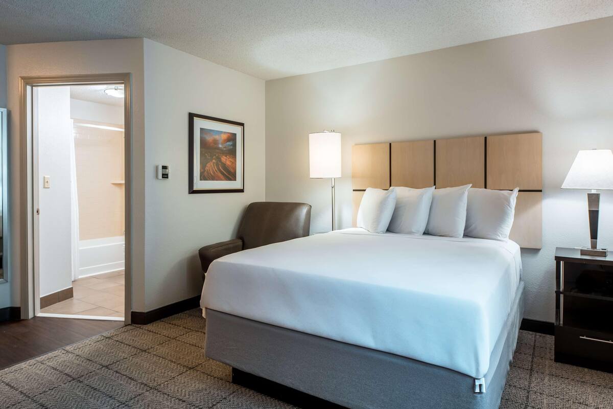 Premium bedding, desk, laptop workspace, blackout curtains