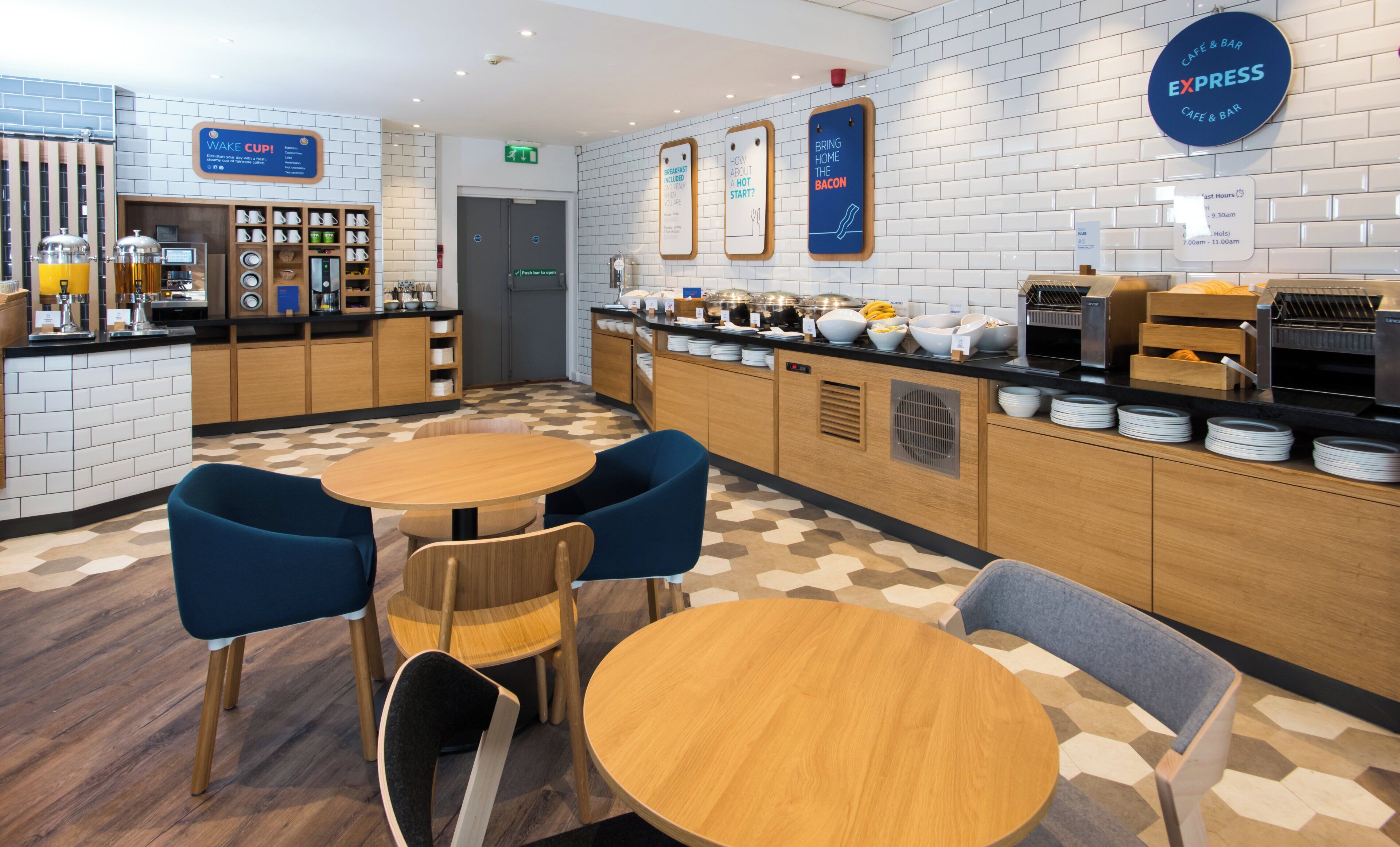 A cafe area with a breakfast bar, seating, and a sign indicating breakfast is included.