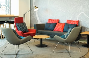 A modern lounge area with a sofa set, two armchairs, a small round table, and a floor lamp. - Holiday Inn Express Bristol City Centre by IHG (Bristol)