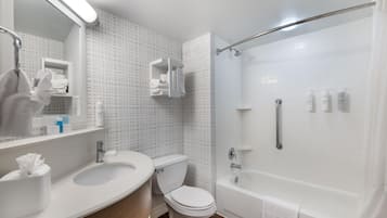 A bathroom with a sink, toilet, and shower.