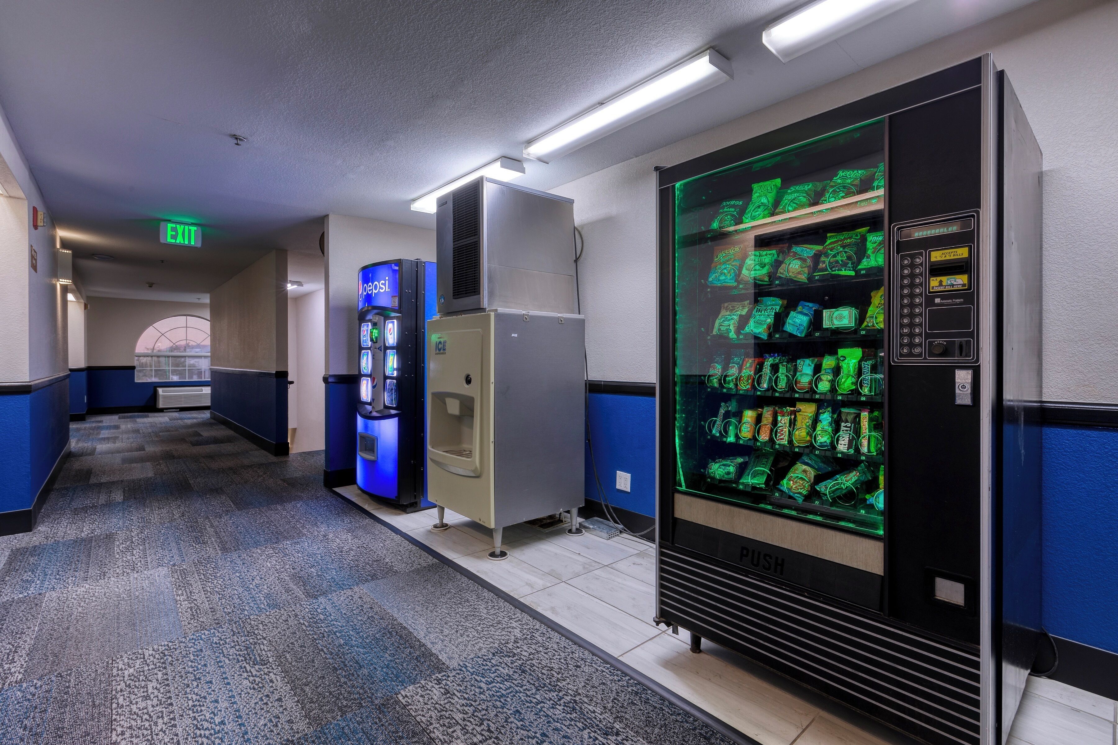 A hotel corridor with vending machines and a push vending machine.
