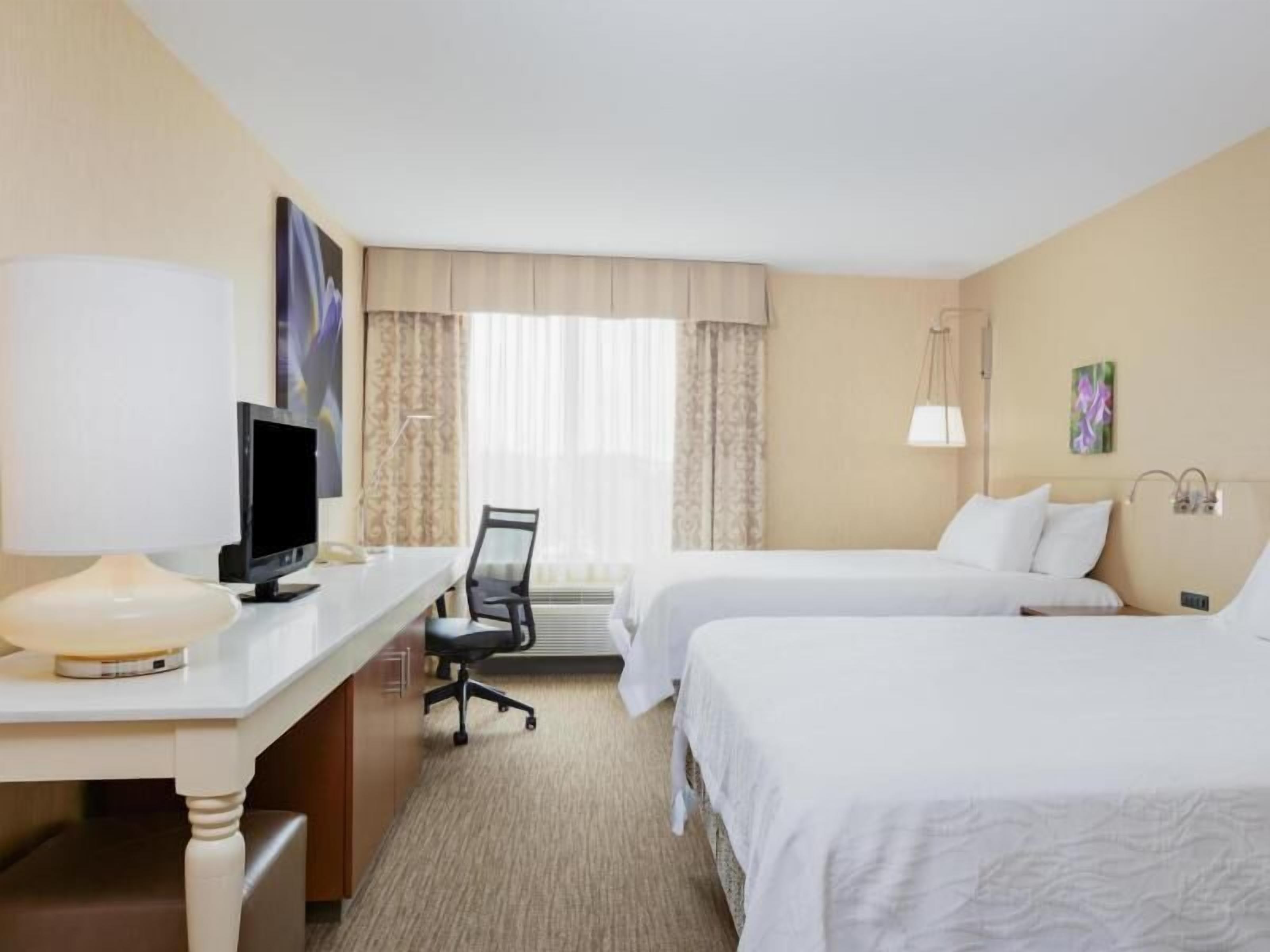 Premium bedding, desk, laptop workspace, iron/ironing board