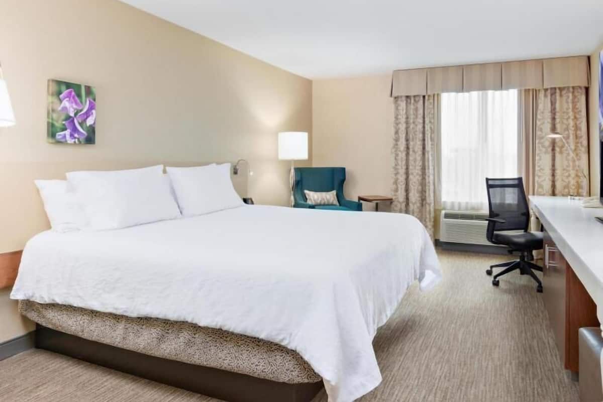 Premium bedding, desk, laptop workspace, iron/ironing board